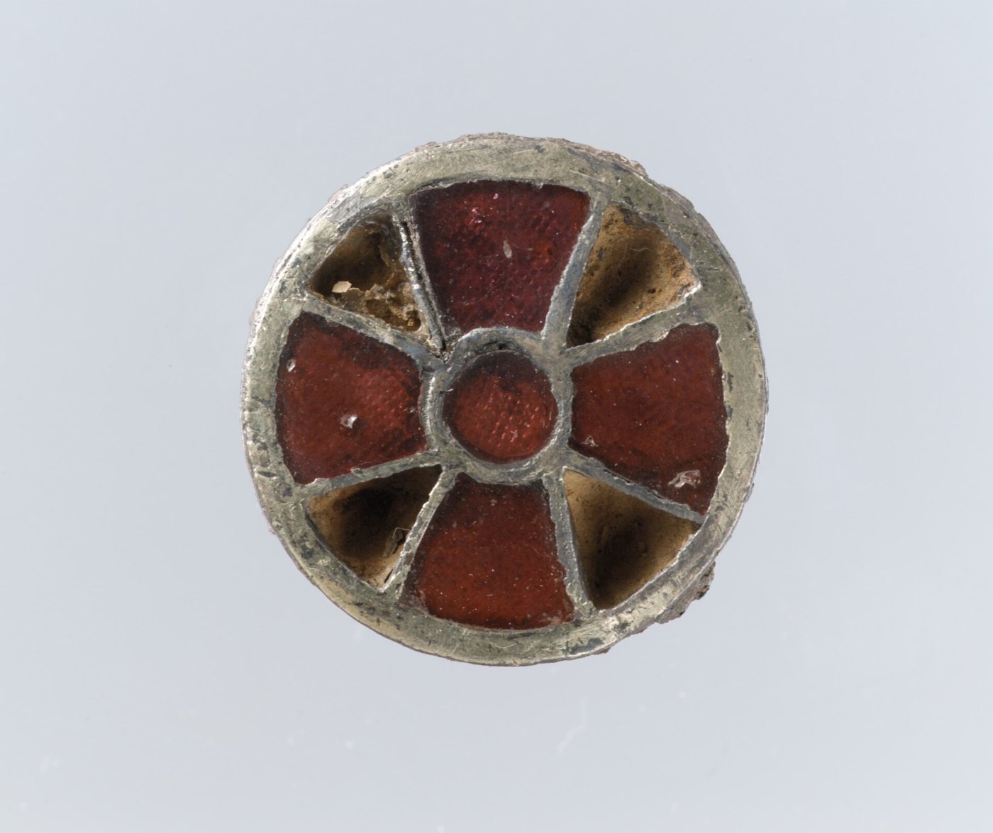 Petite broche ronde en argent doré, ornée de grenats rouges disposés en croix