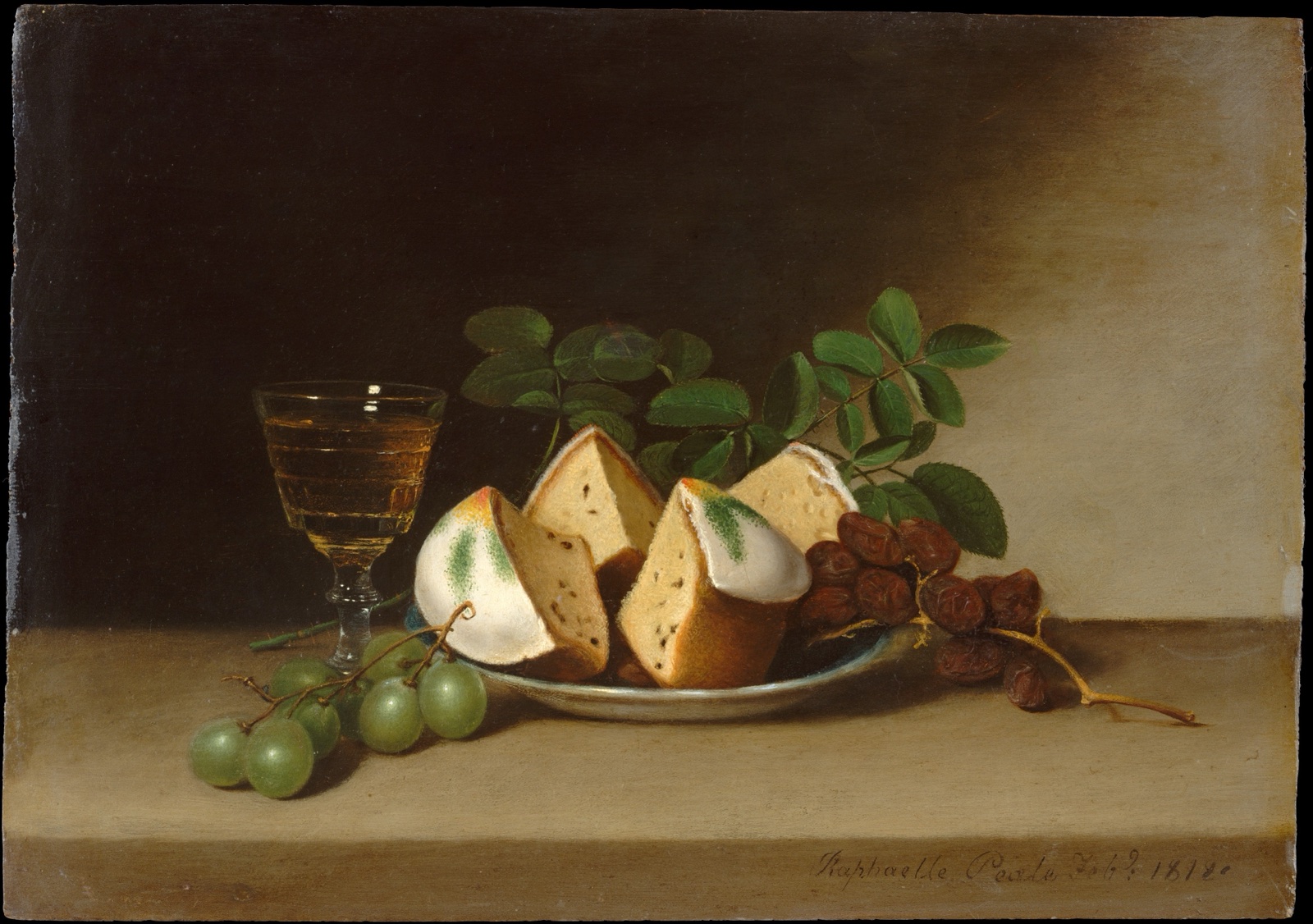 Sur une table, une assiette de parts de gâteau glacé, un verre de vin, une grappe de raisin vert et des dattes, devant un fond sombre