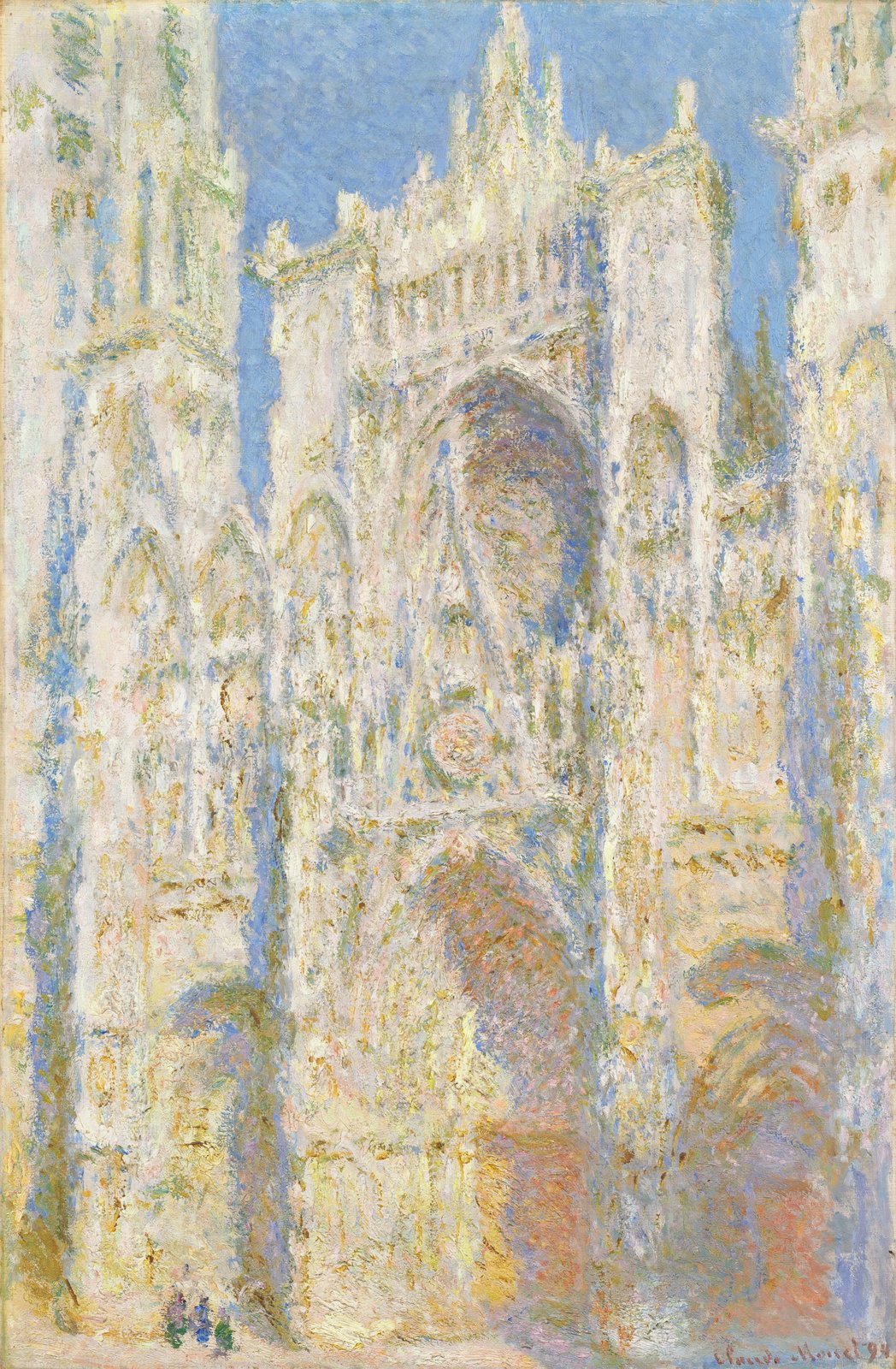 La même façade, cette fois en pleine lumière : la pierre blanche et dorée se détache sur un ciel bleu vif